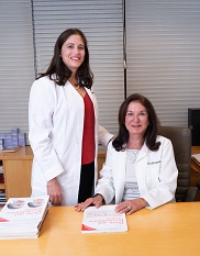 Dr. Copeland-Halperin (left) and Dr. Michelle Copeland seated at desk.